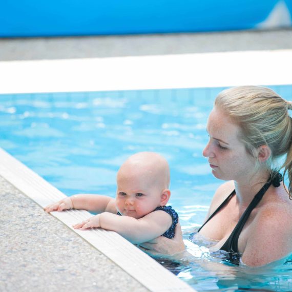 Mother and baby in pool attending lesson